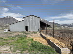 View of pole building with a mountain view