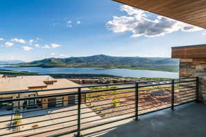Balcony featuring a water and mountain view
