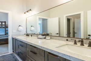Ensuite bathroom with ensuite bath, a sink, and double vanity