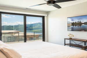 Bedroom with a ceiling fan, a mountain view, and visible vents
