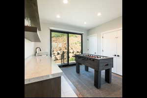 Game room featuring recessed lighting and a sink