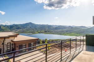 Balcony with a water and mountain view