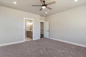 Unfurnished bedroom featuring light carpet, a textured ceiling, baseboards, and visible vents