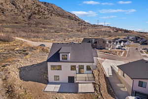Rear view of property with fence, a residential view, a patio, and a mountain view