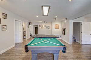 Recreation room with recessed lighting, wood finished floors, baseboards, and billiards