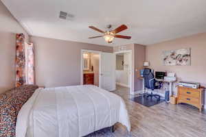 Bedroom featuring wood finished floors, visible vents, baseboards, and ceiling fan