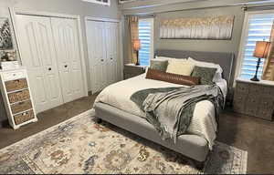 Bedroom with carpet floors and two closets