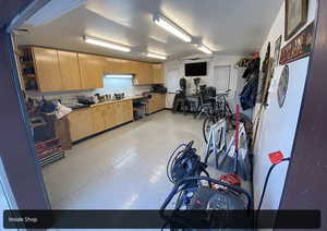 Kitchen with light speckled floor and light brown cabinetry