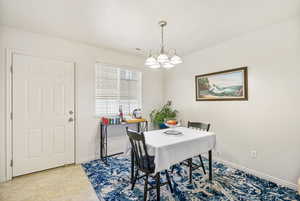 Dining room featuring baseboards, visible vents, an inviting chandelier, and light tile patterned floors
