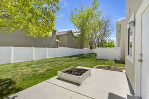 View of yard with a fenced backyard and a patio