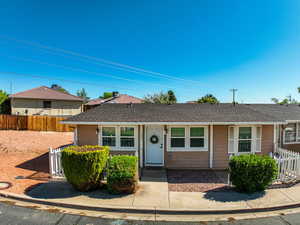 Single story home with fence