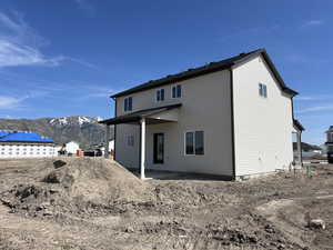 Rear view of property with a mountain view