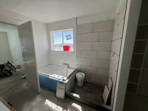 Bathroom featuring a bath and toilet