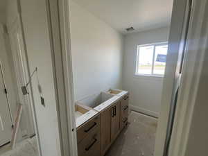 Bathroom with concrete floors and baseboards