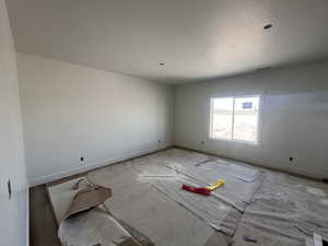 Empty room featuring baseboards and a textured ceiling