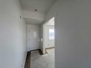 Corridor featuring visible vents and baseboards