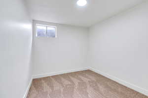 Basement featuring baseboards and carpet floors