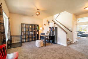 Carpeted office space featuring baseboards