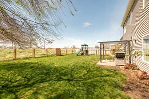 View of yard featuring a fenced backyard and a playground