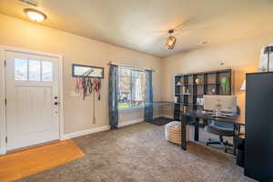Home office featuring baseboards, visible vents, and carpet