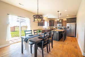 Dining space with recessed lighting, an inviting chandelier, visible vents, light wood-style floors, and baseboards