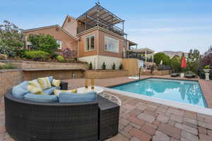 View of swimming pool with an outdoor living space, a patio, and a fenced in pool