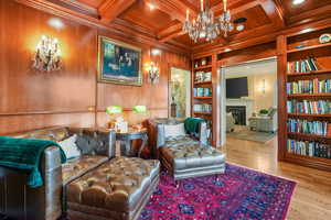 Library room with crown molding, wooden walls, and built in bookshelves.  Opens to back yard entertainment area.