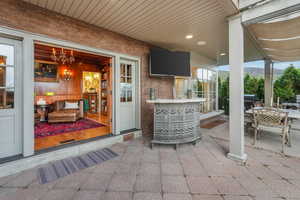 Entertaining patio featuring grilling area, a mountain view, outdoor dining space, and seating area.