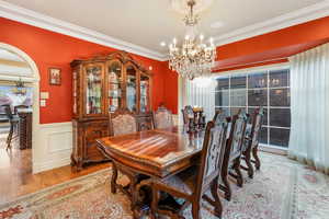 Currently used as the Formal Dining area with wood finished floors, wainscoting, ornamental molding, and an inviting chandelier.  Previously a formal Living Space or Office.