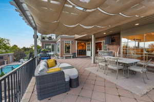 View of patio / terrace featuring outdoor dining area and a fenced in pool