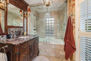 Primary Full bath featuring tiled shower / bath combo, plenty of natural light, and vanity