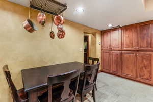 Dining area featuring recessed lighting, stone tile flooring, and visible vents