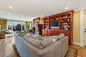 Living area featuring recessed lighting, visible vents, and a large fireplace