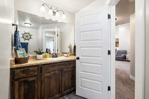 Bathroom featuring lofted ceiling, ensuite bath, and vanity