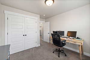Office area featuring baseboards and carpet
