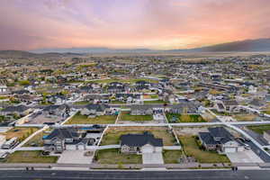 Aerial view at dusk featuring a mountain view and a residential view