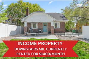 Back of property with a chimney, a porch, and brick siding