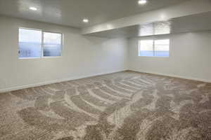 Below grade area featuring baseboards, carpet, and recessed lighting