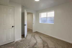 Unfurnished room with carpet floors and baseboards