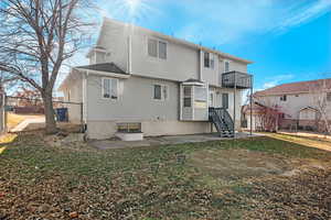 Rear view of property with fence and a balcony