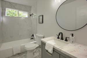 Full bathroom with toilet, shower / bathtub combination, and vanity