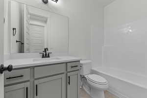 Bathroom with vanity, tile patterned floors, and shower / tub combination
