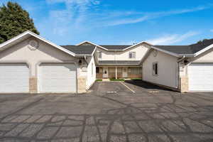 View of front of home featuring covered porch and stucco siding