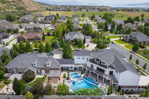 Aerial perspective of suburban area with a pool area and mountains