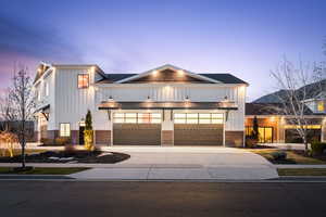 Modern inspired farmhouse with board and batten siding, a standing seam roof, and brick siding