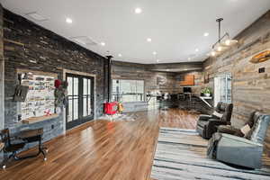 Living room featuring wood finished floors, french doors, and recessed lighting