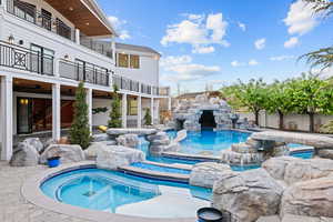 View of pool featuring a patio area and a pool with connected hot tub