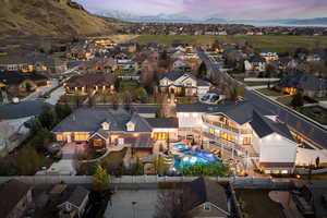Aerial perspective of suburban area featuring a mountainous background and a pool area
