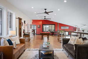 Living room featuring ceiling fan, billiards, lofted ceiling, wood finished floors, and recessed lighting