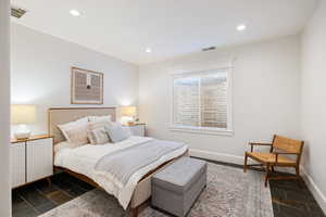 Bedroom featuring recessed lighting, baseboards, and stone tile floors